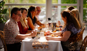 A group of people sat around a table enjoying dinner