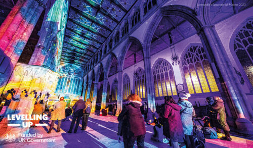 A picture of Southwell minster full of people The buildings interior is lit up in pink and purple lights In the bottom right are three logos which reads Levelling Up and Funded by UK Government