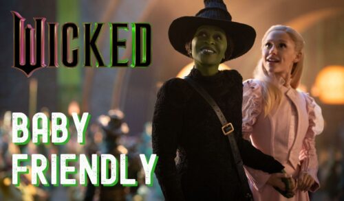 A green witch in a black cloak and hat stands next to another witch in a pink dress In the top left corner is the Wicked logo Below the logo is a title that reads Baby Friendly